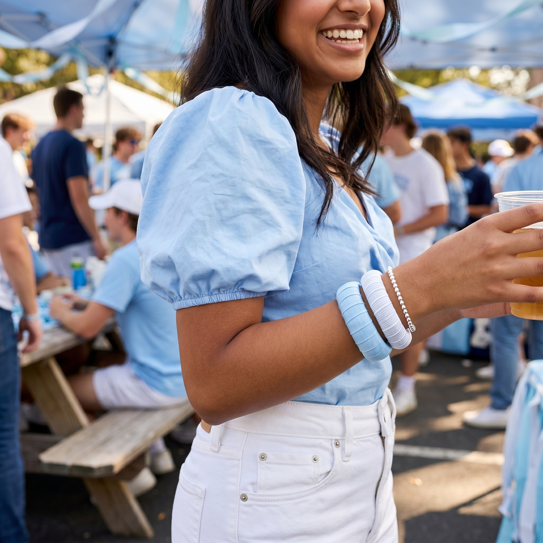 Woman wearing light blue white pButter Republic bracelets