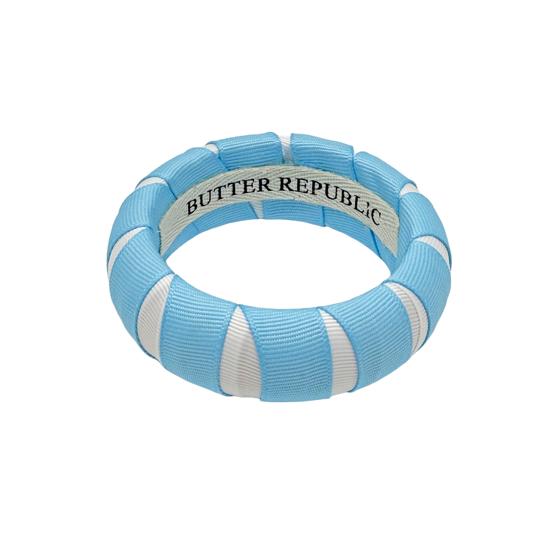 Light blue and white Butter Republic bracelet with brand label on the interior