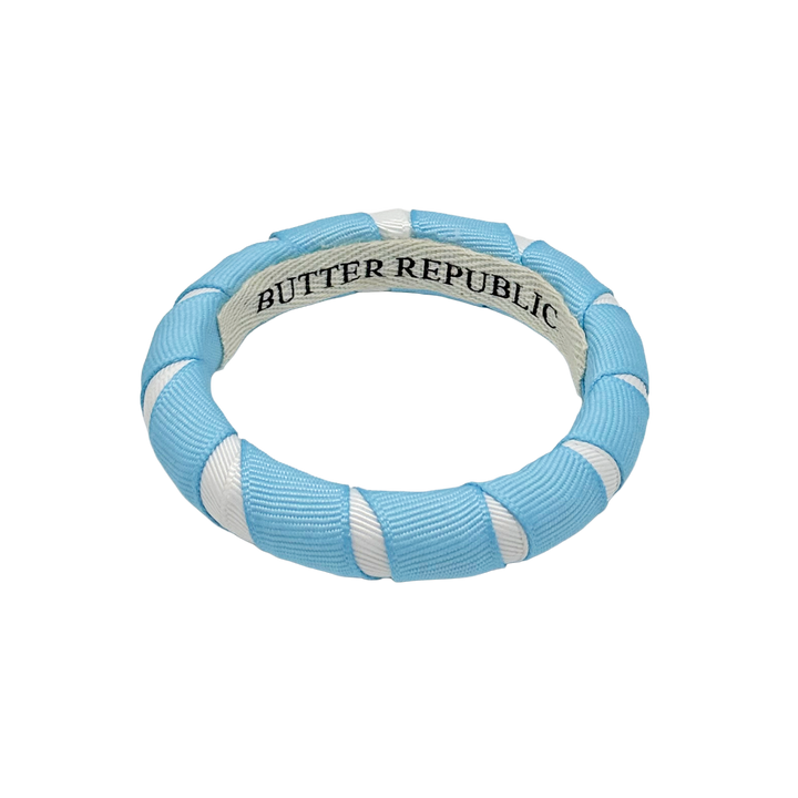 Light blue and white Butter Republic bangle bracelet with brand label on the interior
