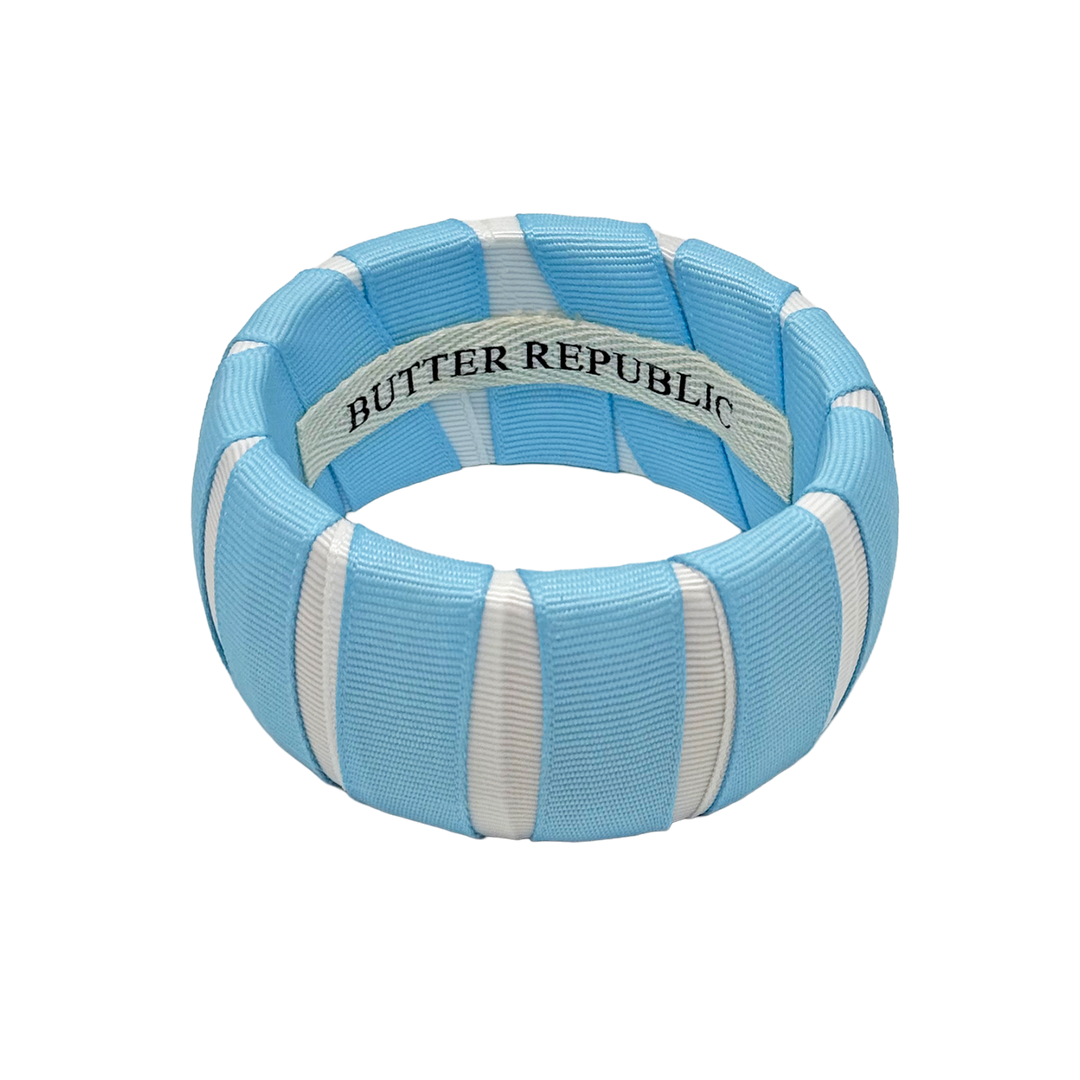 Light blue and white Butter Republic bangle with brand label on the interior