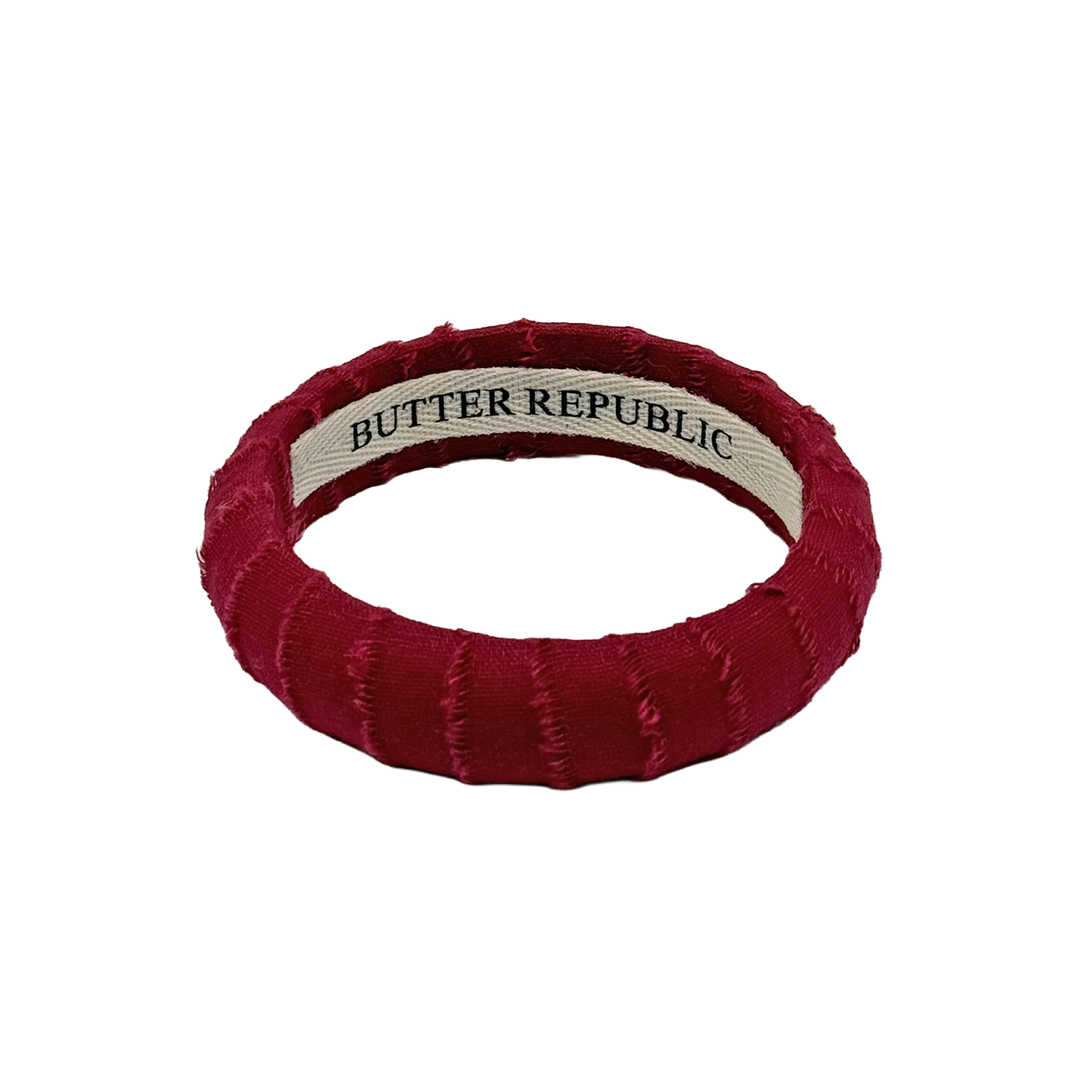 maroon frayed Butter Republic bracelet with logo brand label on the interior of the bracelet