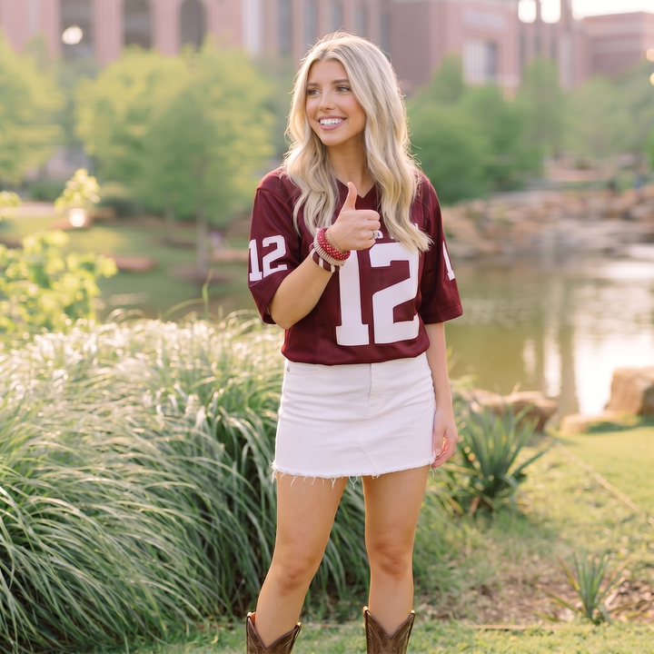 Woman wearing three maroon and white Butter Republic bracelets