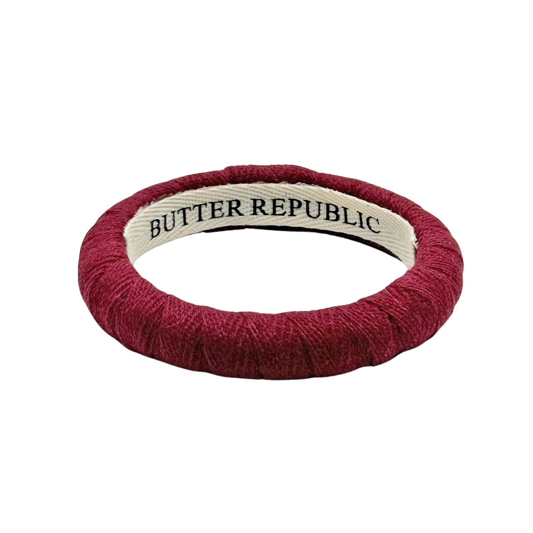 Maroon narrow bangle bracelet with 'Butter Republic' label on the interior