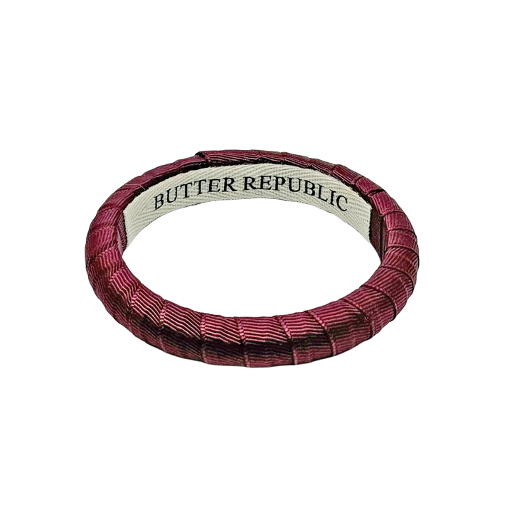 maroon narrow Butter Republic bracelet with logo branding label on the interior of the bracelet