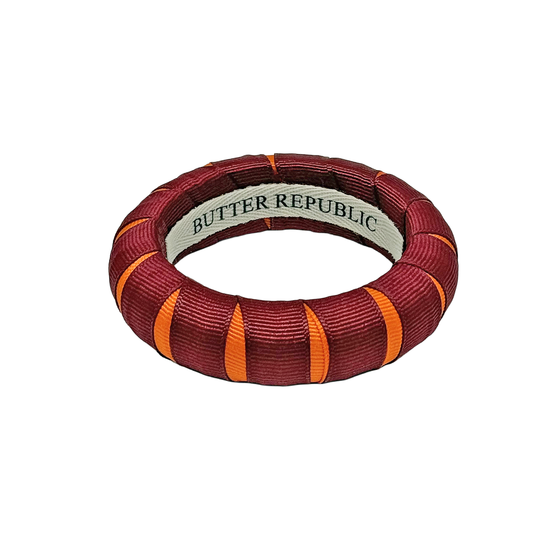 A maroon and orange Butter Republic bracelet