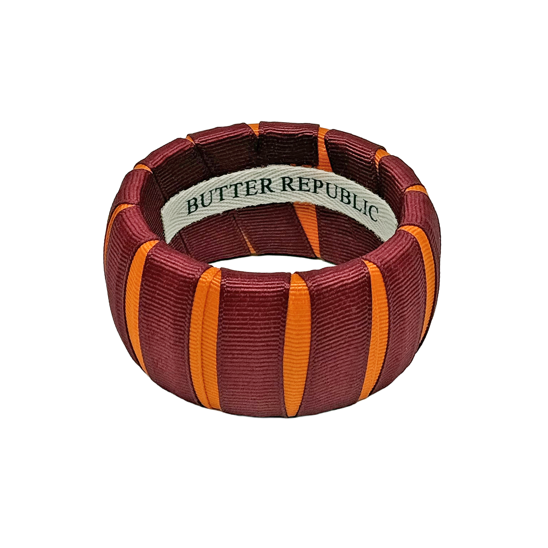 A wide maroon and orange Butter Republic bracelet