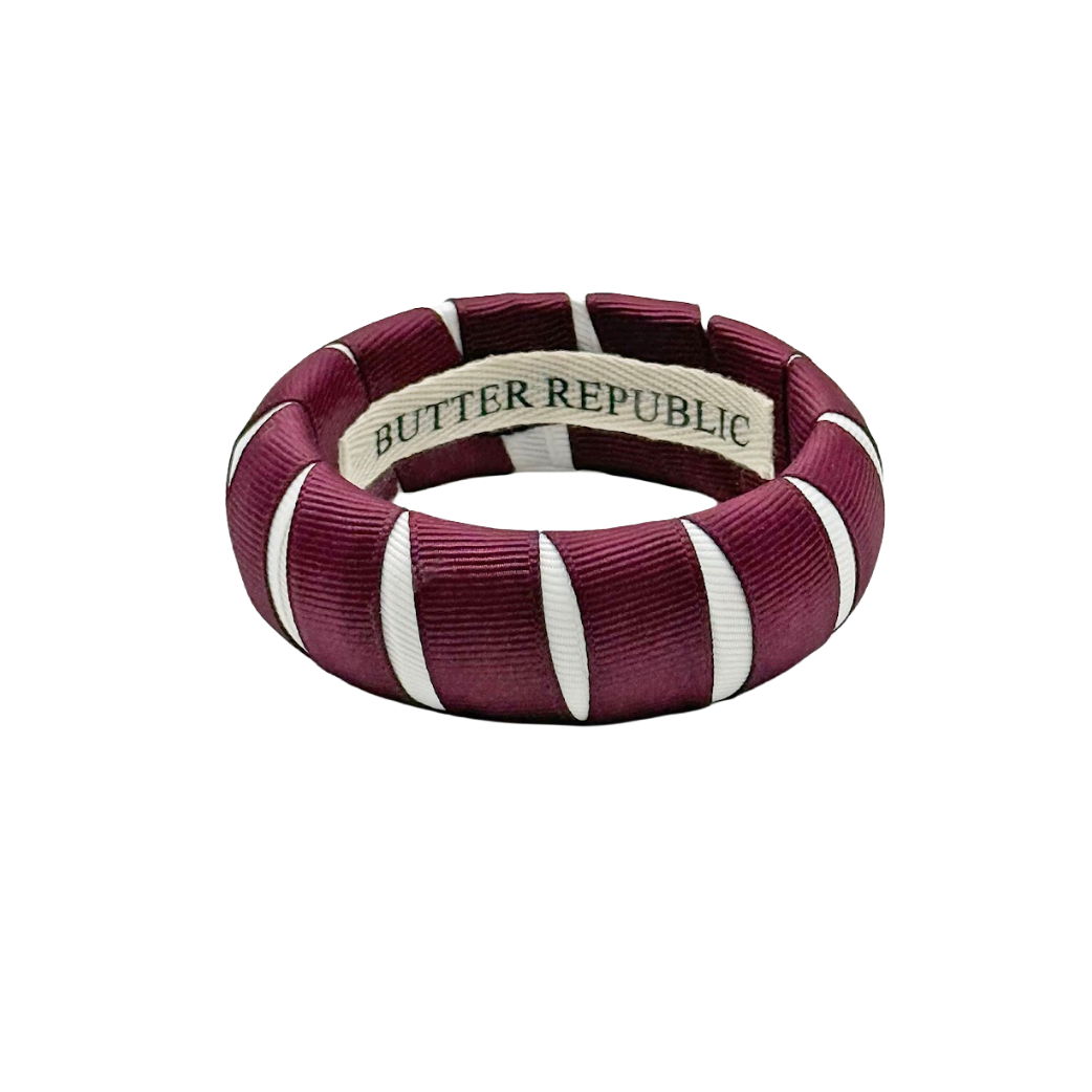 Maroon and white bracelet with 'Butter Republic' label on the interior