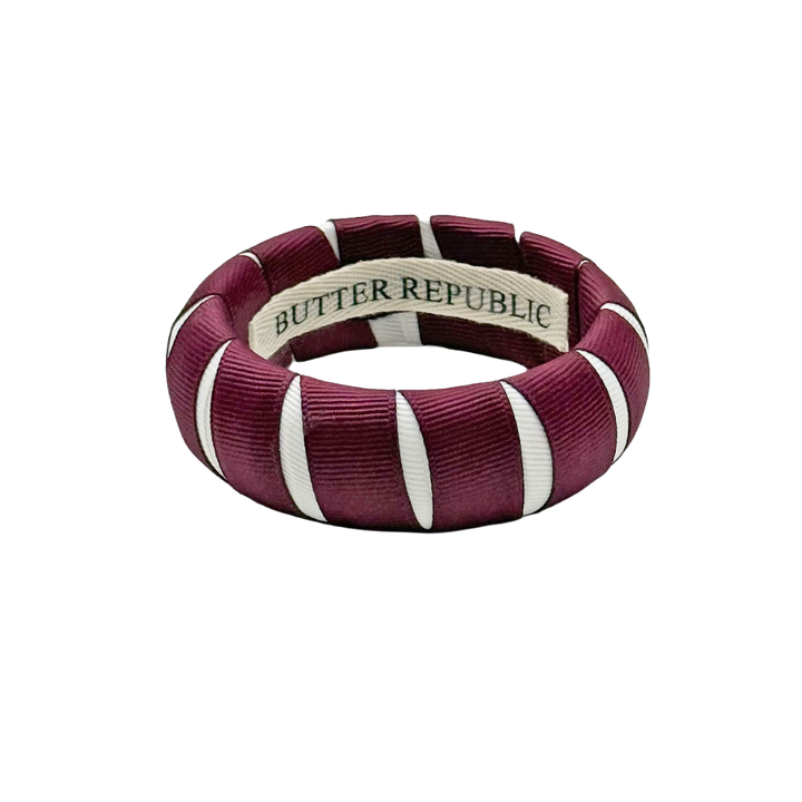 maroon and white Butter Republic bracelet with a logo brand label on the interior of the bracelet