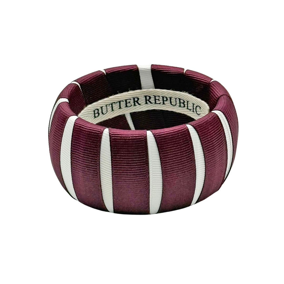 Maroon and white bangle bracelet with 'Butter Republic' branding on the interior