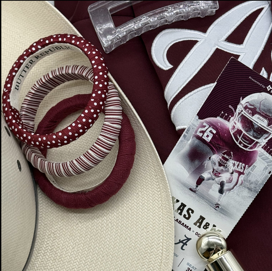 maroon and white ticket stub, straw cowboy hat, three assorted Butter Republic maroon and white bangle bracelets with branding label on the interior