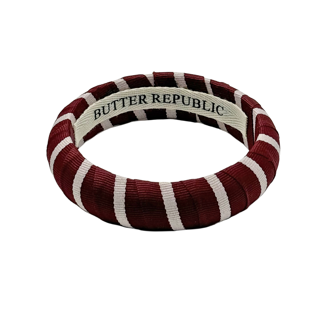 Maroon and white stripe bracelet with 'Butter Republic' branding on the interior