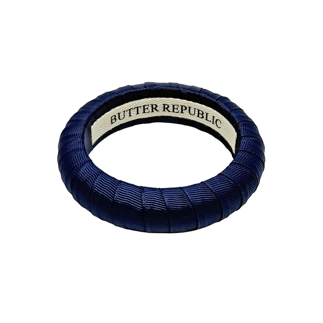 Blue bracelet with 'Butter Republic' branding on the interior