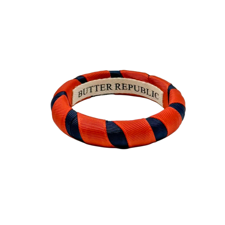navy blue and orange Butter Republic bracelet with logo brand label on the interior of the bracelet