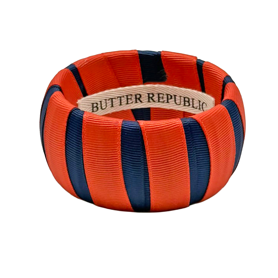 Orange and navy bracelet with 'Butter Republic' label affixed to the inside