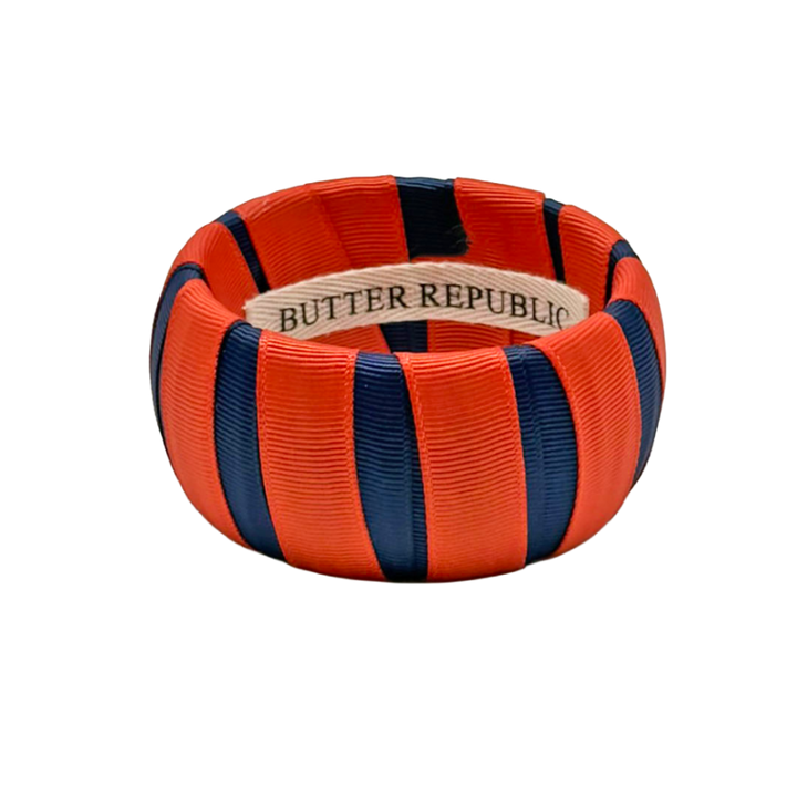orange and navy Butter Republic bracelet with logo brand label on the interior of the bracelet