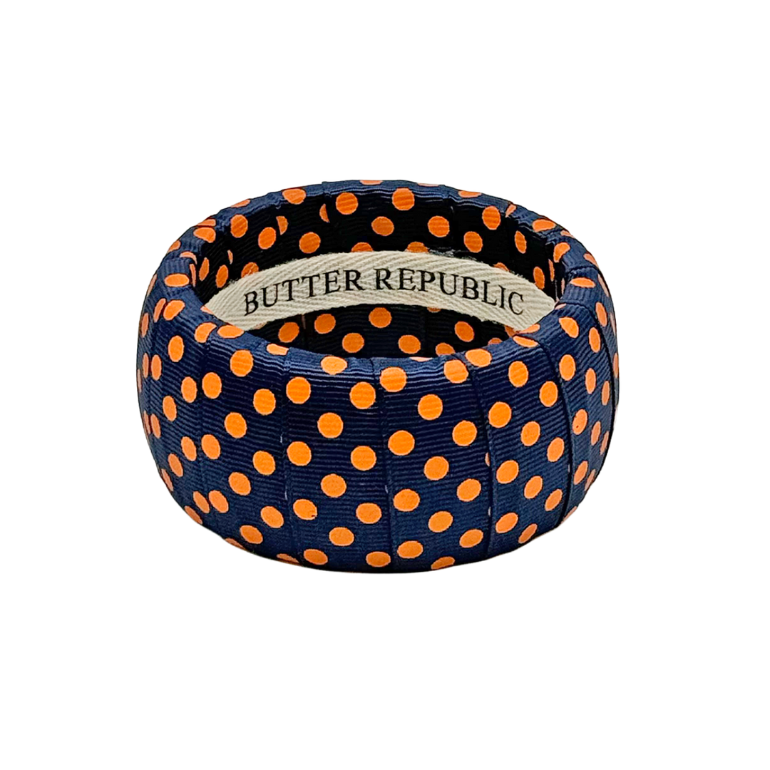 Wide navy blue Butter Republic bracelet with orange polka dots