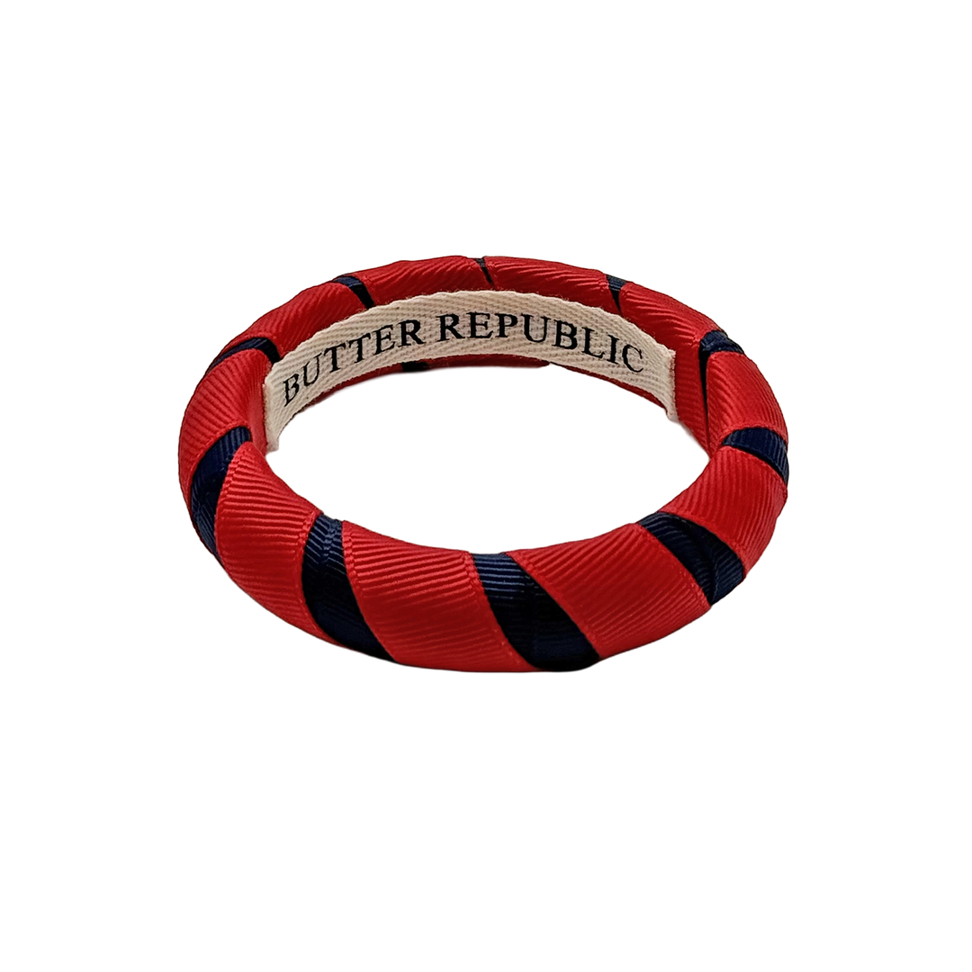 Red and navy blue bracelet with 'Butter Republic' branding on an interior label