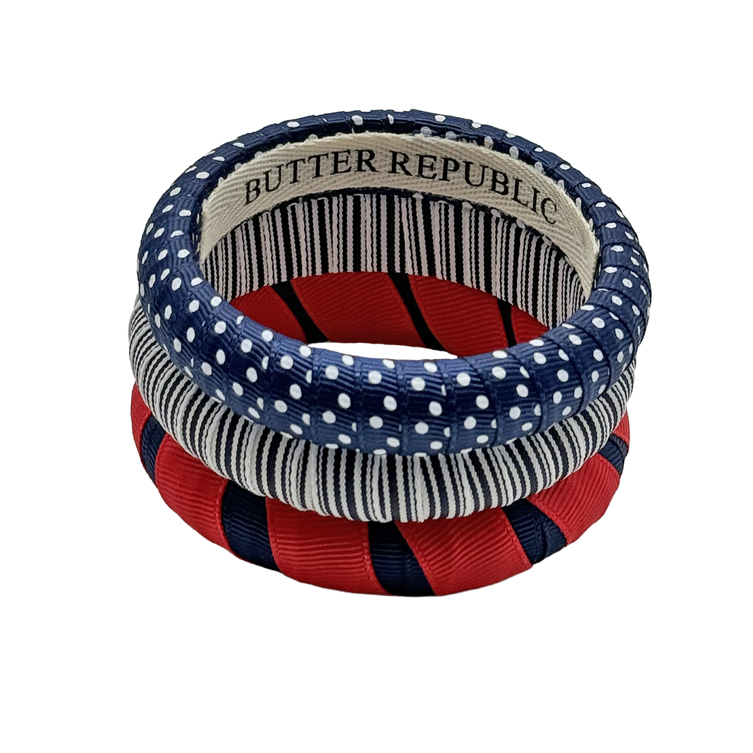 Set of three navy blue and red bracelets with Butter Republic branding