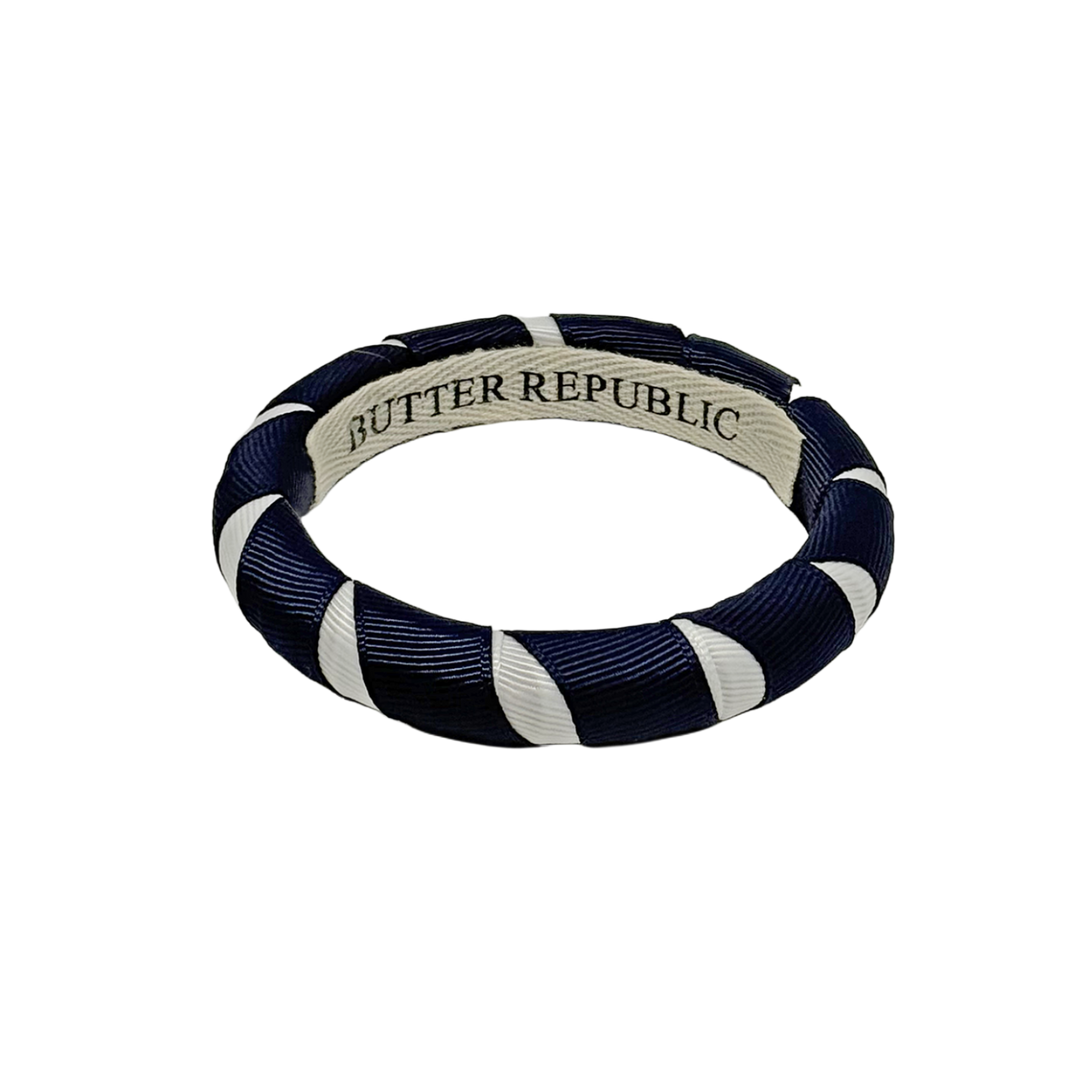 A navy blue and white Butter Republic bangle bracelet 