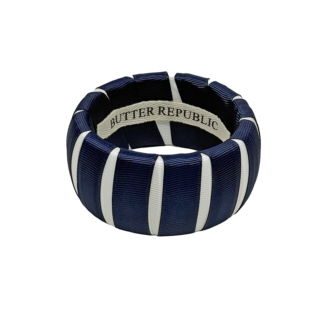 A wide navy blue and white Butter Republic bangle bracelet