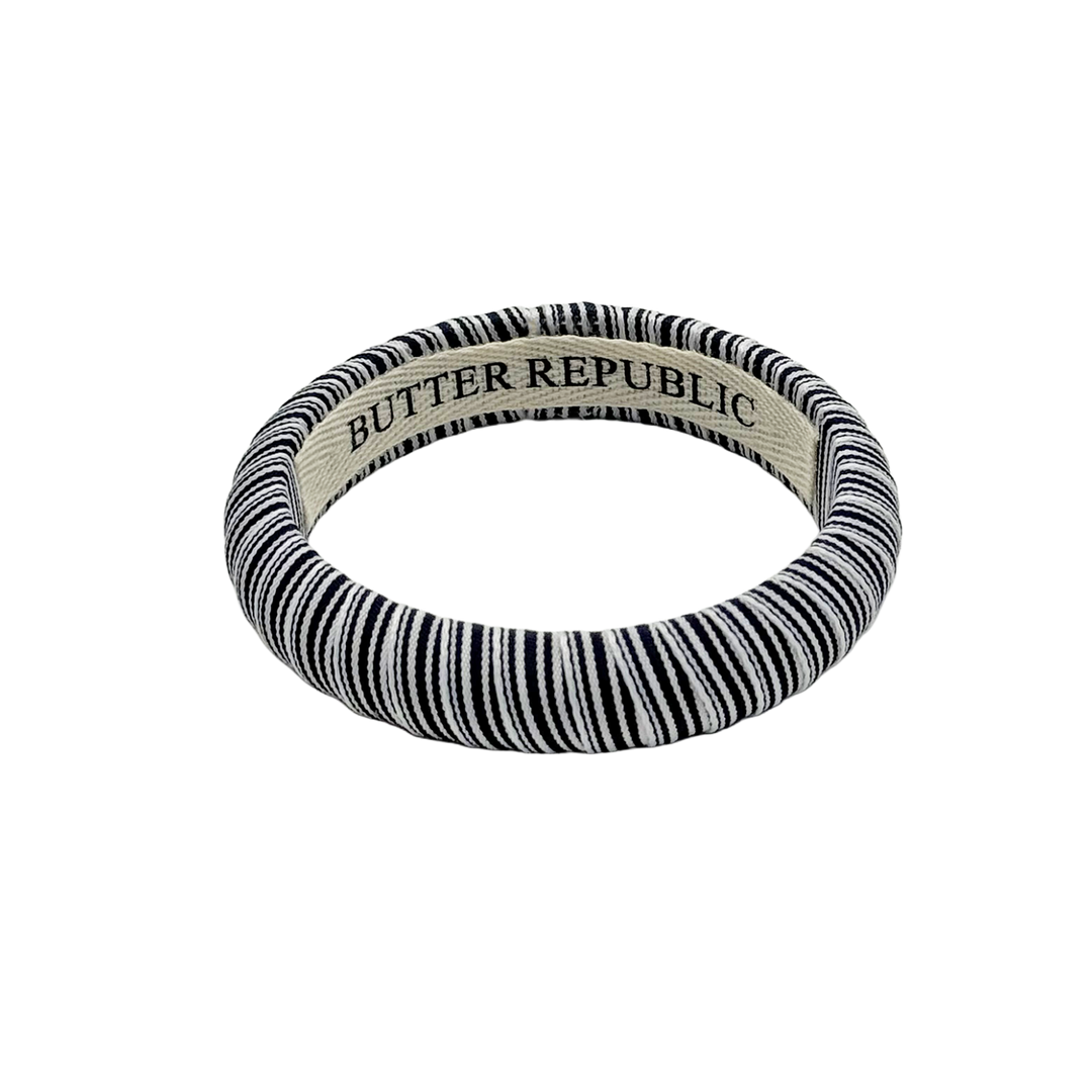 Navy blue and white striped bracelet with 'Butter Republic' branding on the interior