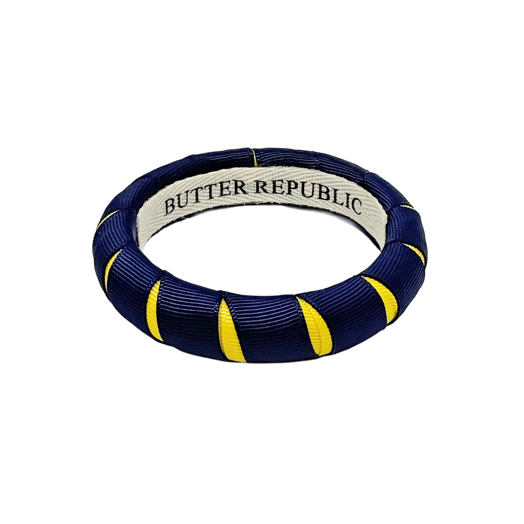 A navy blue and yellow Butter Republic bangle bracelet