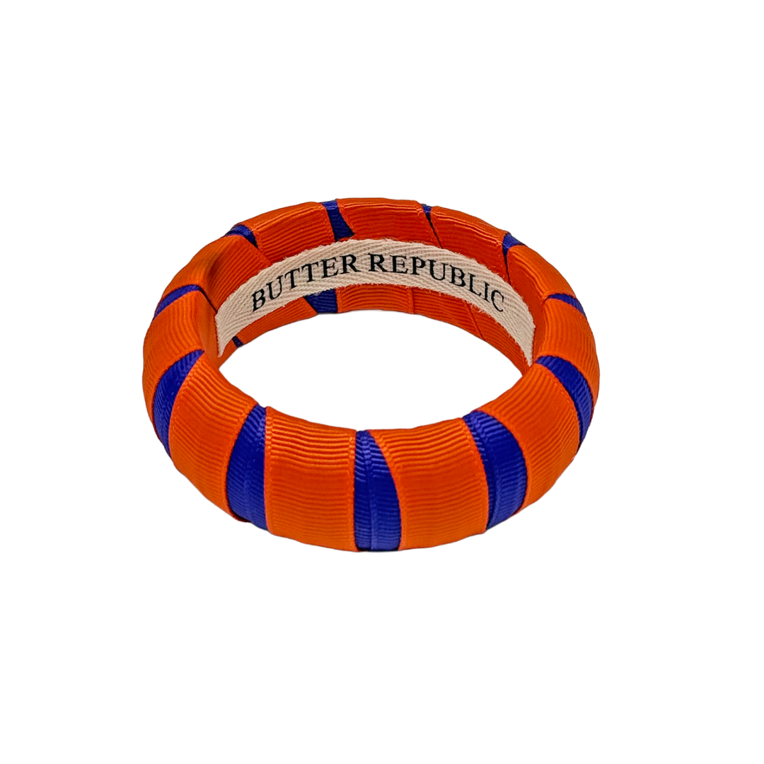 Orange and purple Butter Republic bracelet with brand label on the interior