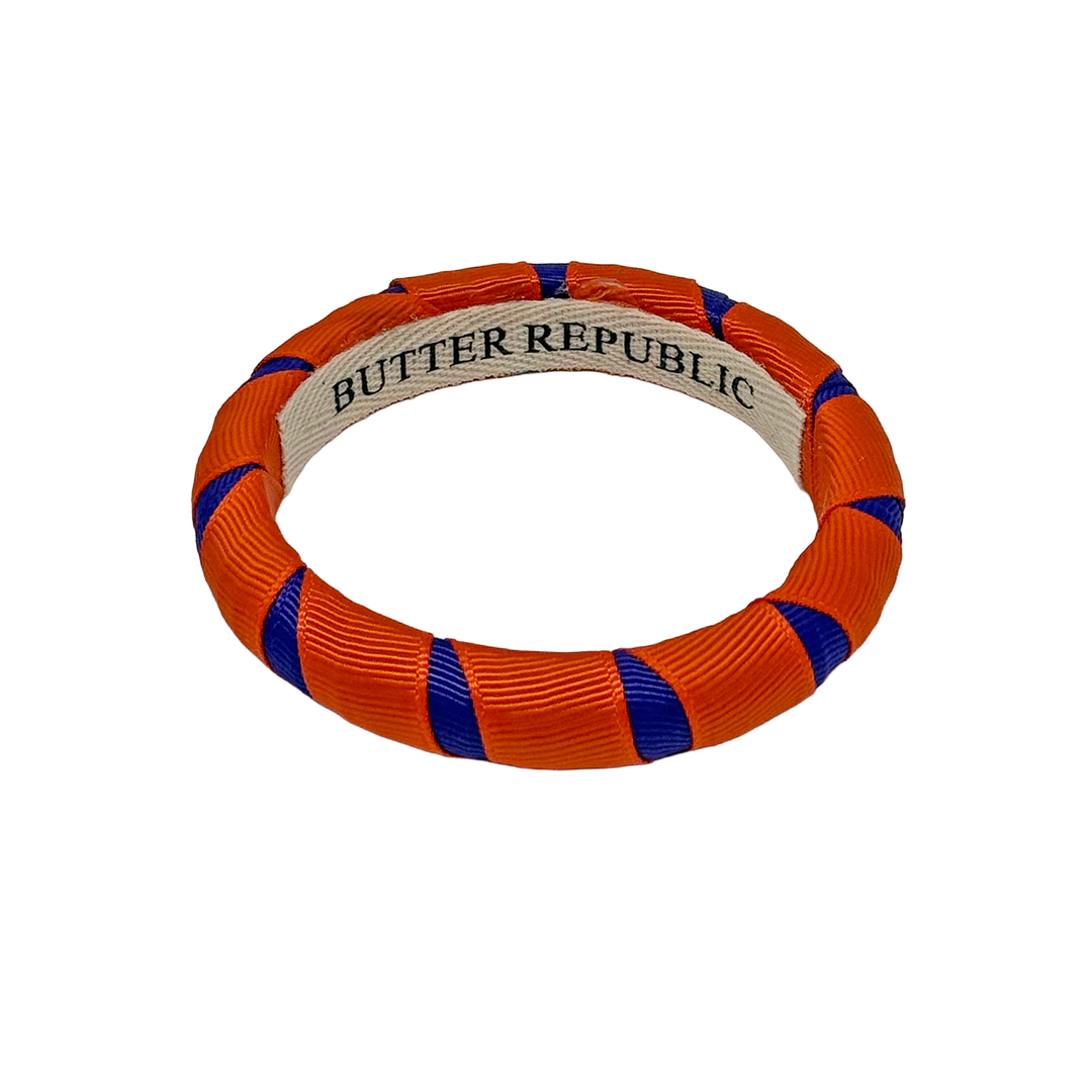 Orange and purple Butter Republic bracelet with a brand label on the interior