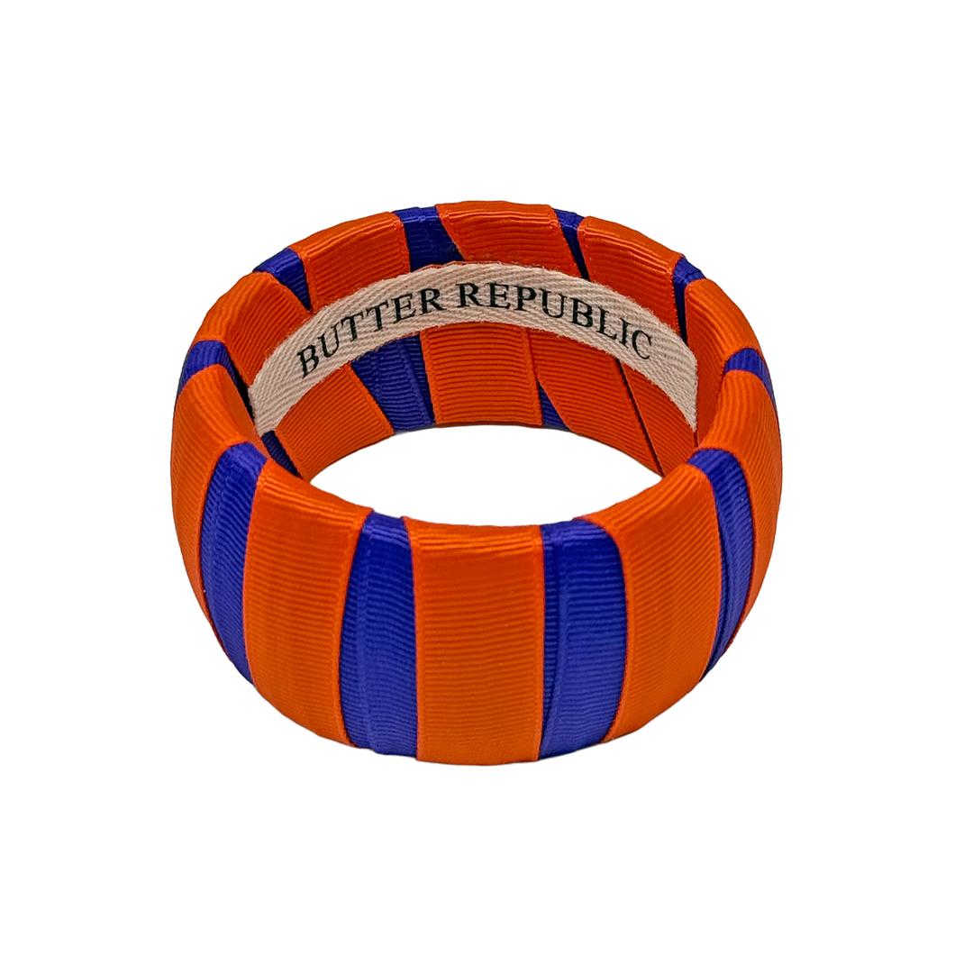 Orange and purple Butter Republic bangle with brand label on the interior