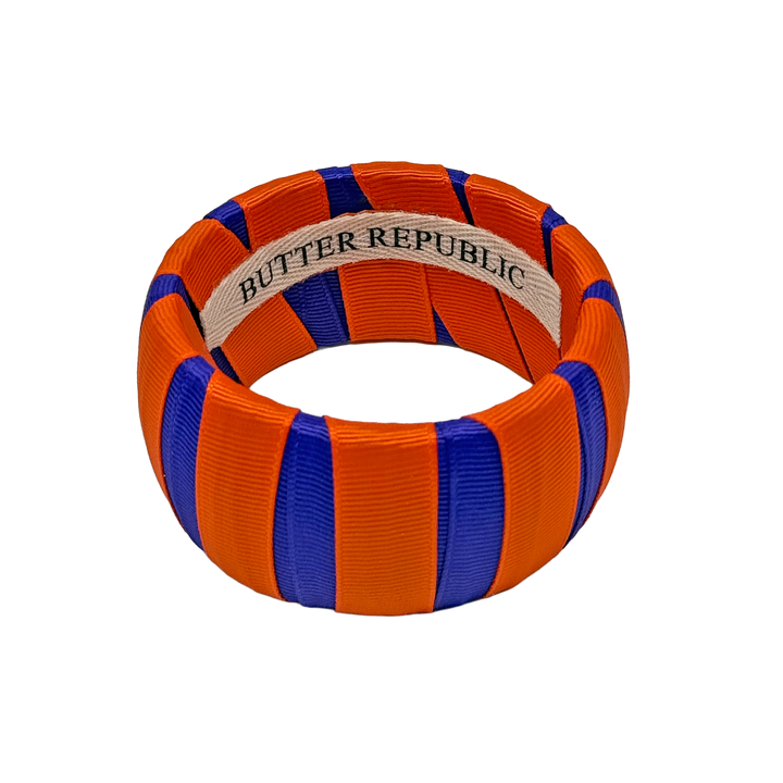 Orange and purple Butter Republic bangle with brand label on the interior