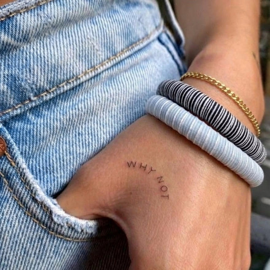 hand of a woman with a tattoo &