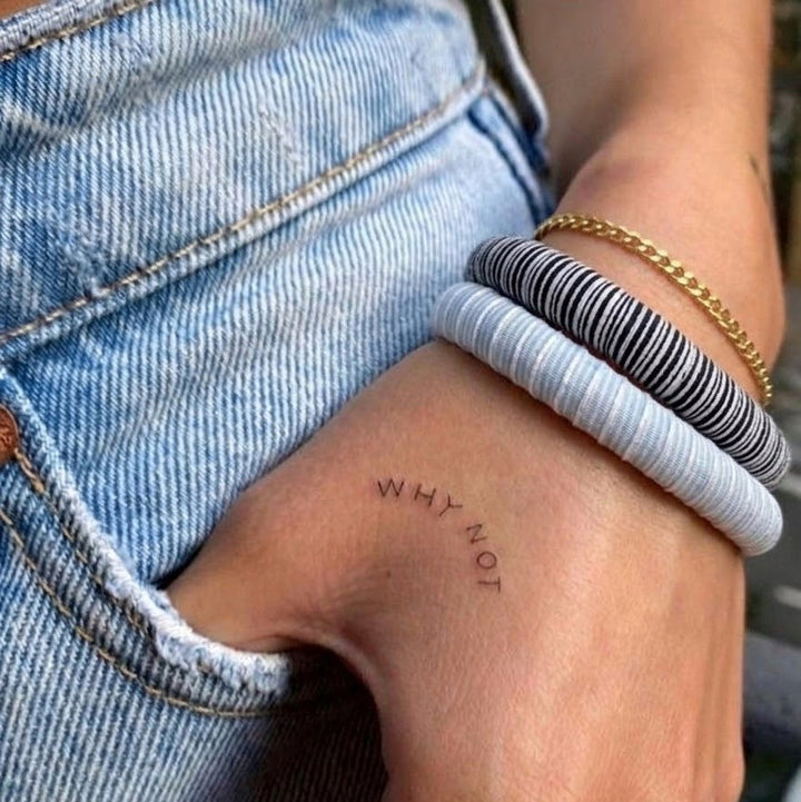 hand of a woman with a tattoo &