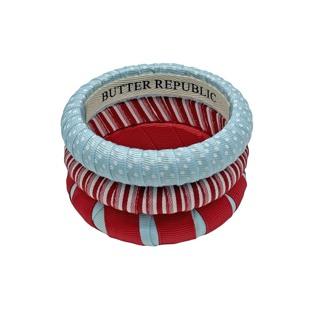 three powder blue and red Butter Republic bracelets with interior branding label