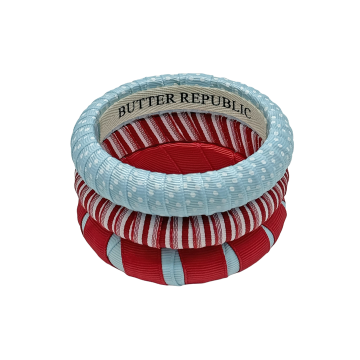 three powder blue and red Butter Republic bracelets with interior branding label