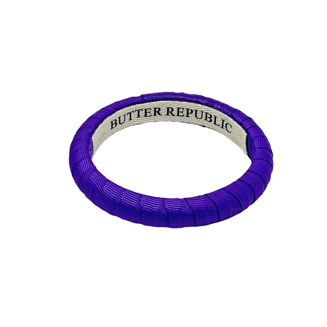 purple narrow Butter Republic bracelet with brand name on an interior label