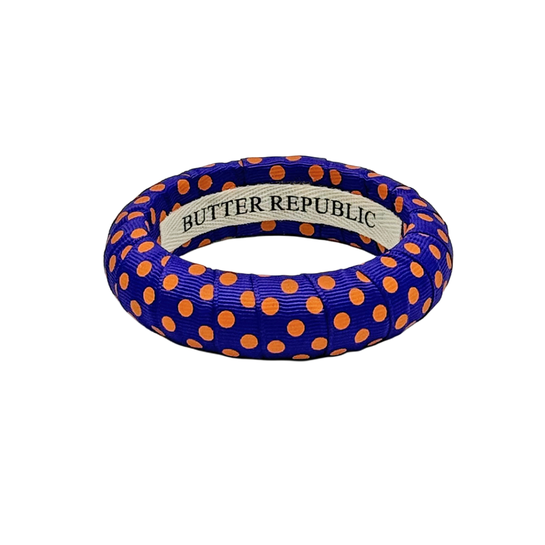 Purple Butter Republic medium width bangle bracelet with orange polka dots