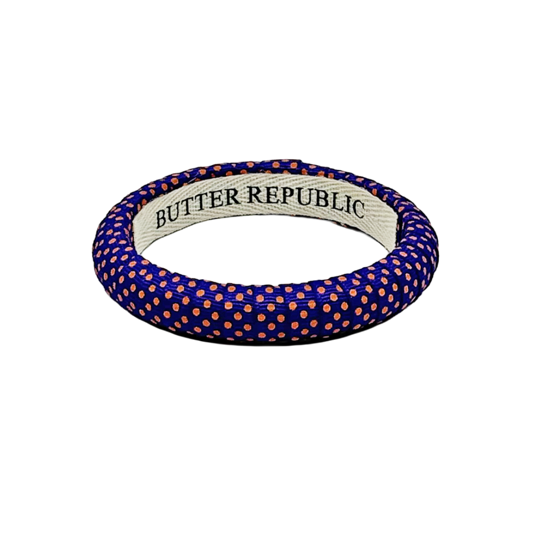 Purple Butter Republic narrow bangle bracelet with small orange Swiss dot polka dots
