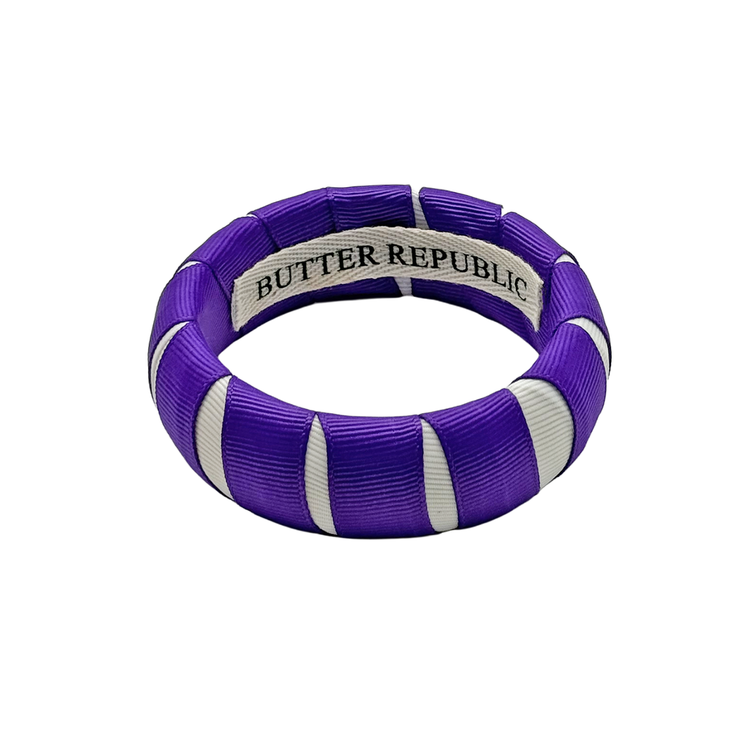 purple and white Butter Republic bracelet with a brand label on the interior of the bracelet