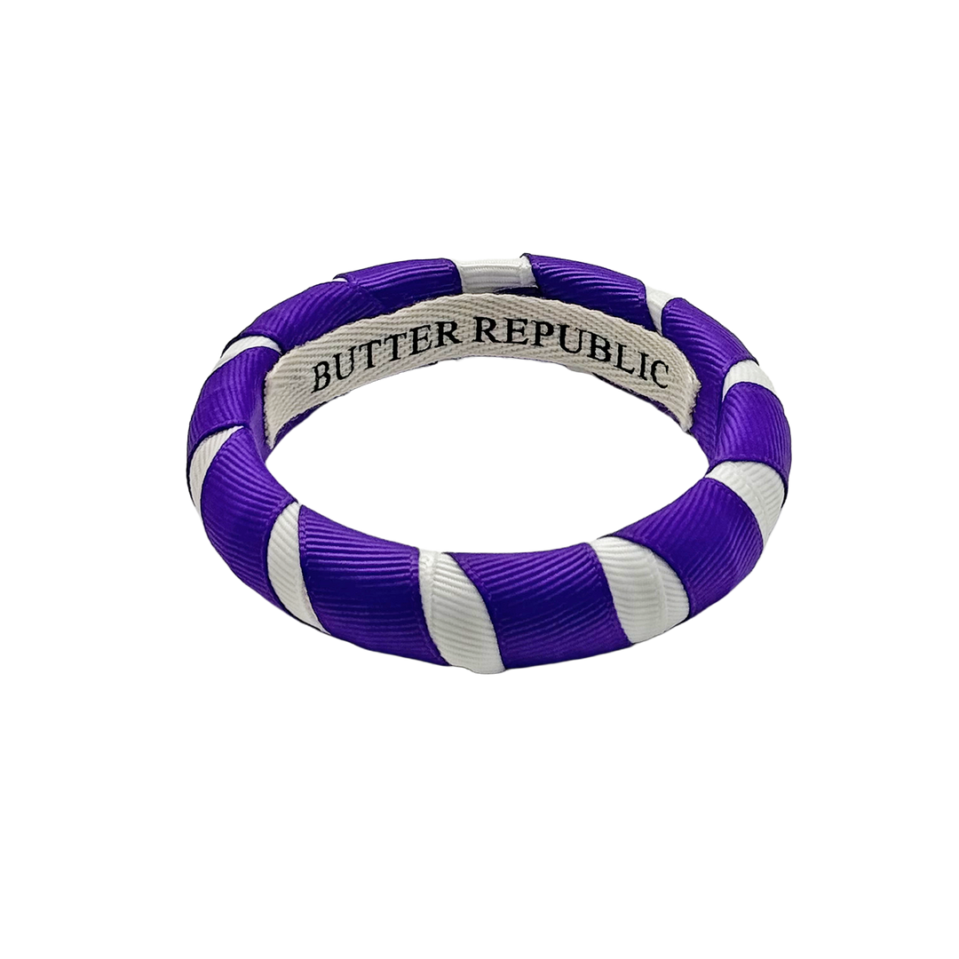 purple and white Butter Republic bracelet with a brand label on the interior of the bracelet
