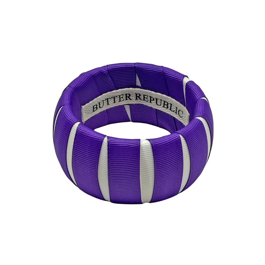 purple and white Butter Republic bracelet with a brand label on the interior of the bracelet