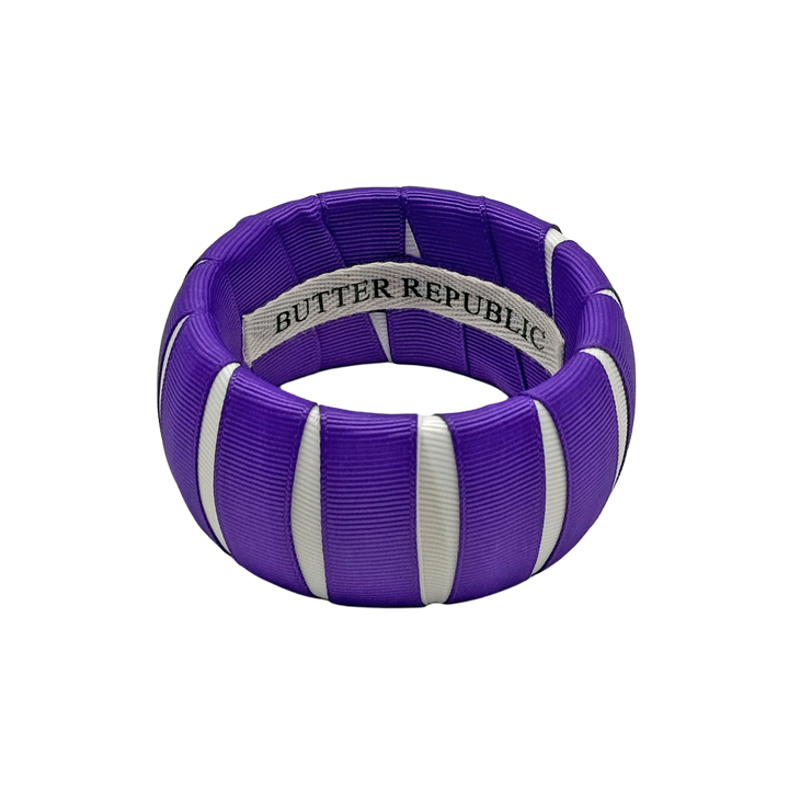 purple and white Butter Republic bracelet with a brand label on the interior of the bracelet