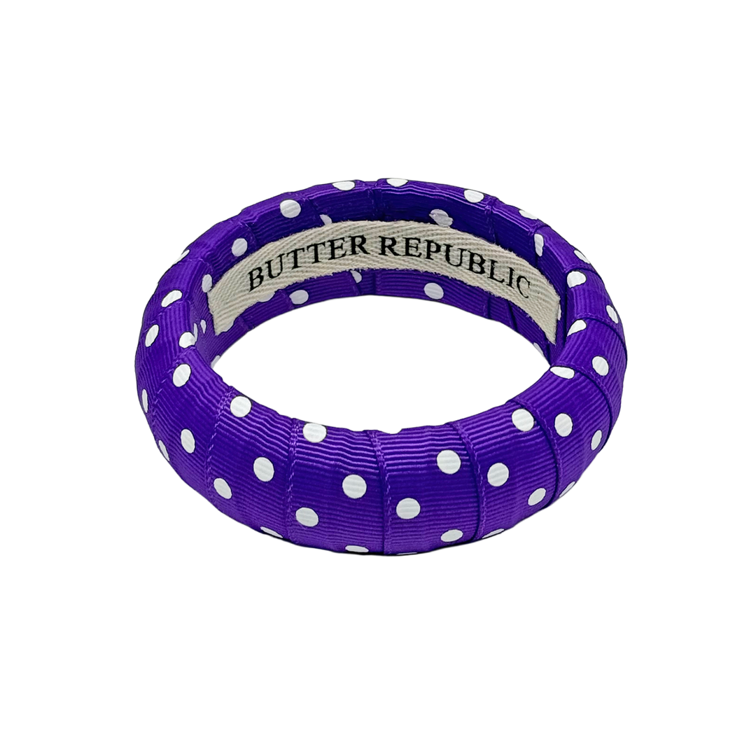 Purple and white polka dot bracelet with Butter Republic brand label on the interior