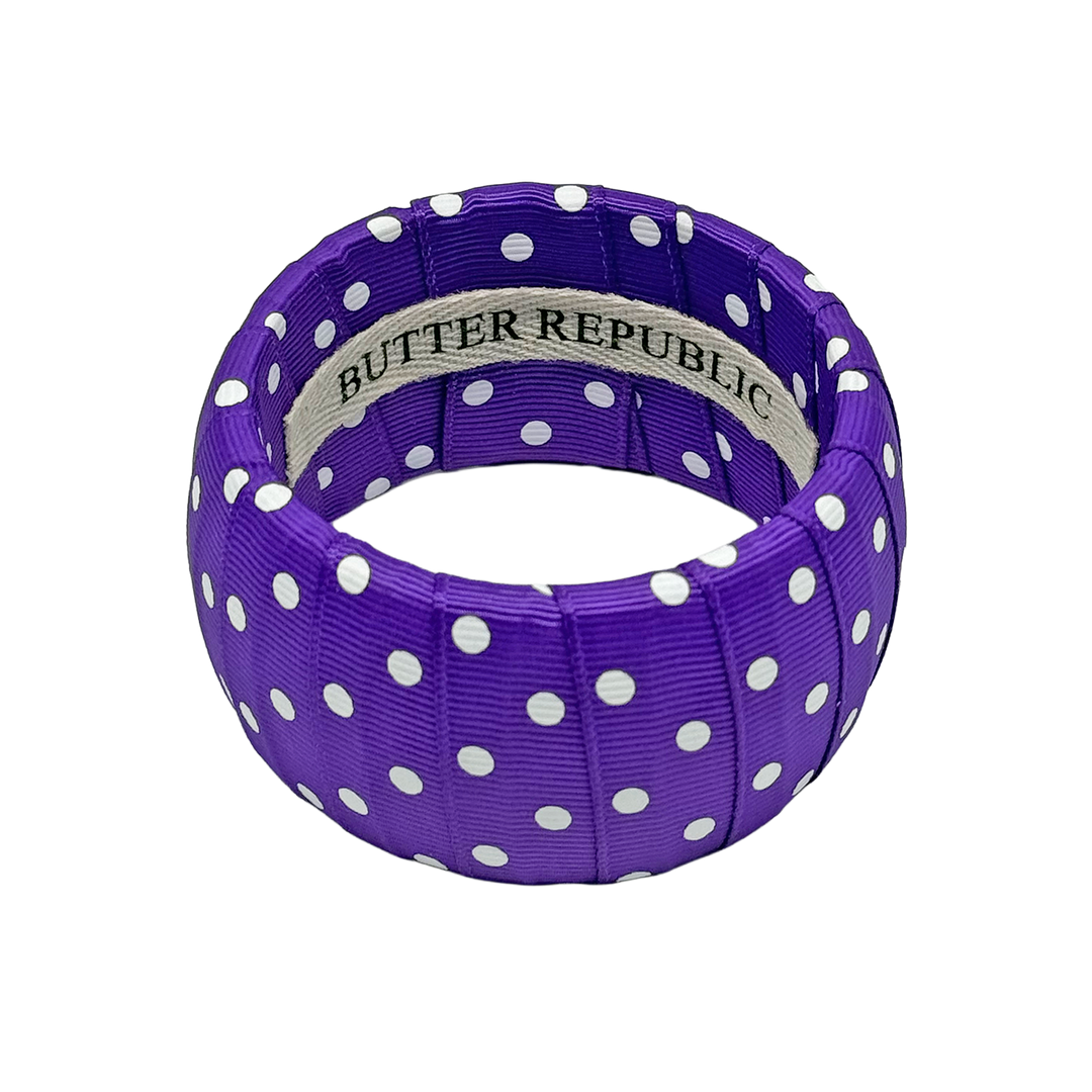 Purple and white polka dot bracelet with Butter Republic brand label on the interior