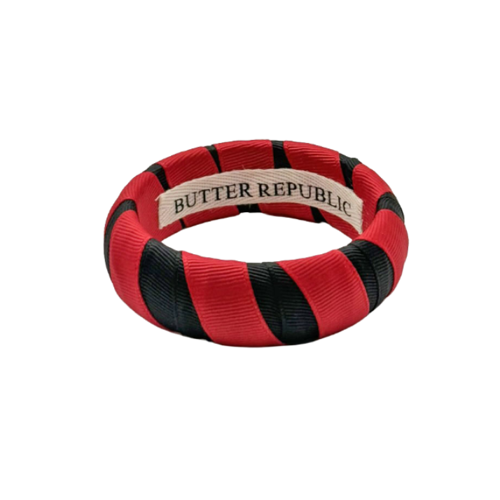 red and black Butter Republic bracelet with a brand label on the interior of the bracelet
