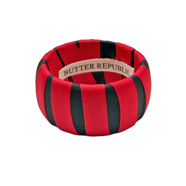 red and black wide Butter Republic bracelet with a brand label on the interior of the bracelet