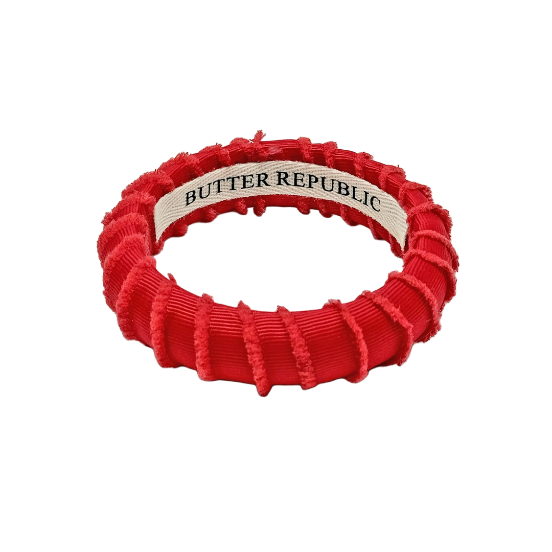 A red frayed fabric Butter Republic bracelet