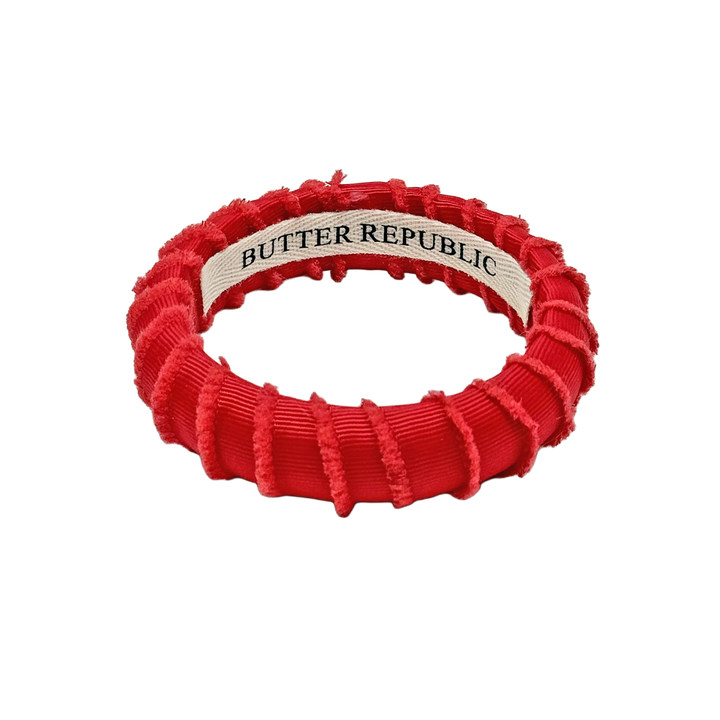 A red frayed fabric Butter Republic bracelet