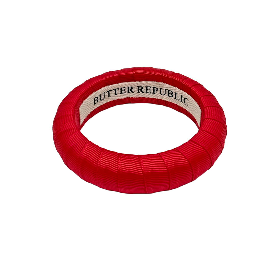 Red bracelet with 'Butter Republic' brand label on the interior