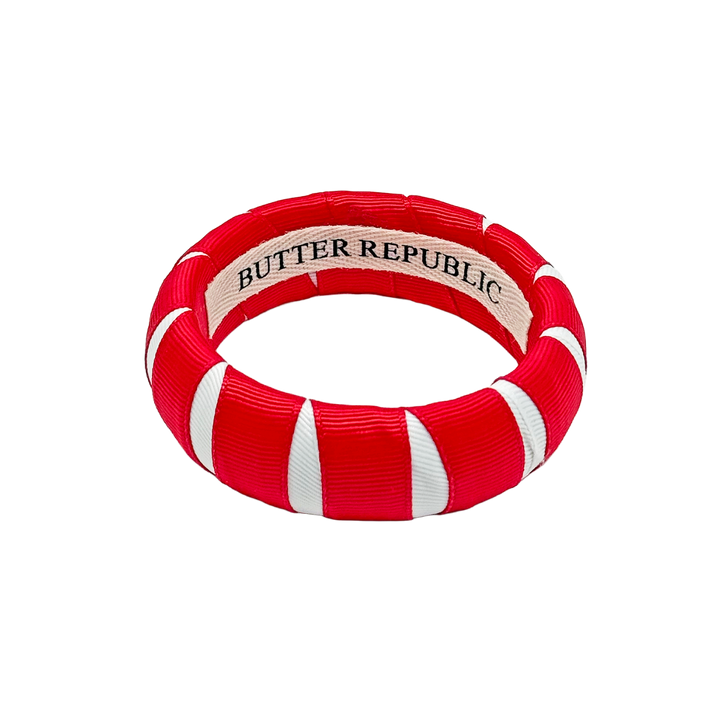 red and white Butter Republic bracelet with a logo brand label on the interior of the bracelet