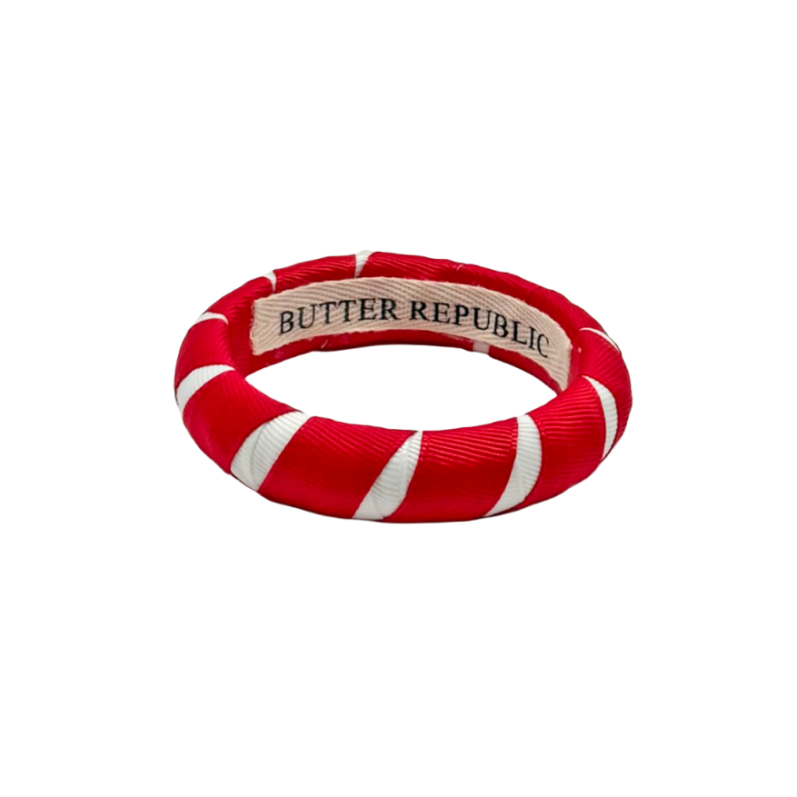 red and white Butter Republic bracelet with a logo brand label on the interior of the bracelet